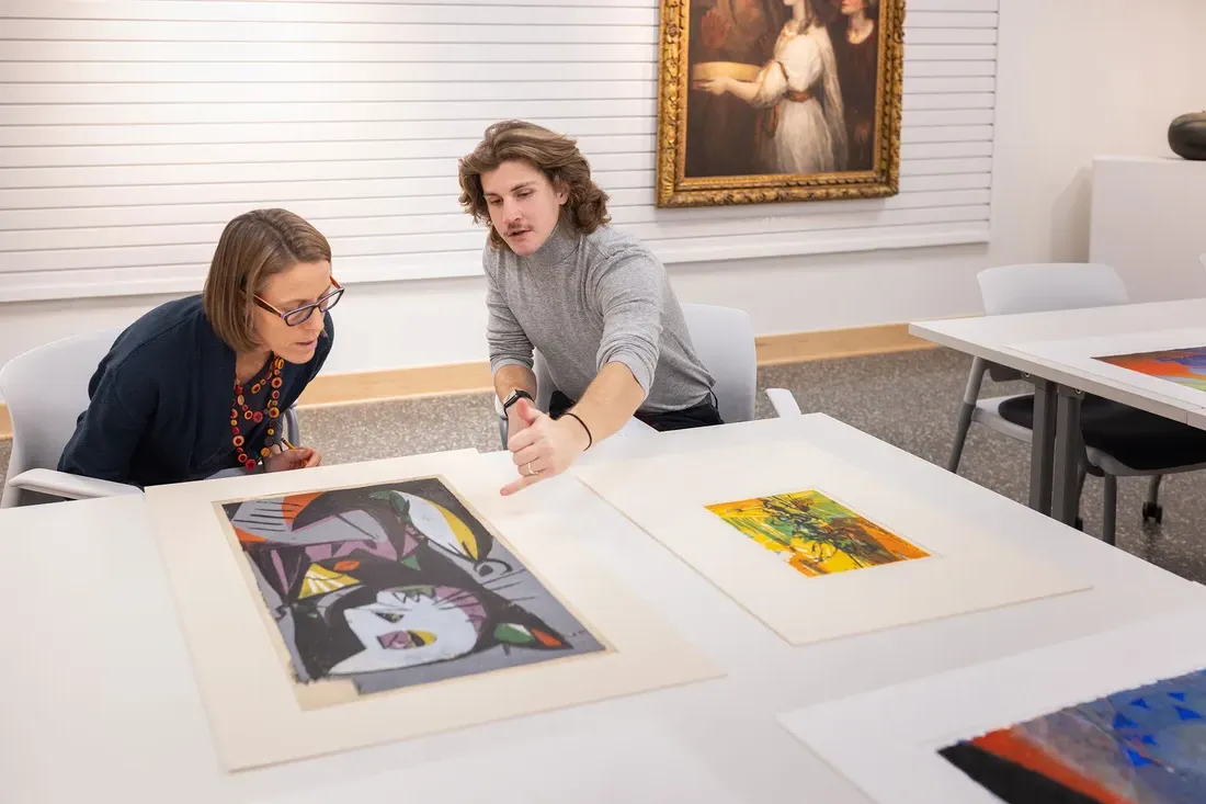 a student and professor performing a museum review together.